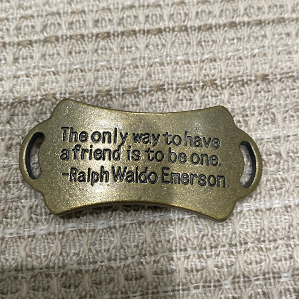 Gold bracelet charm with a quote from ralph waldi emerson
